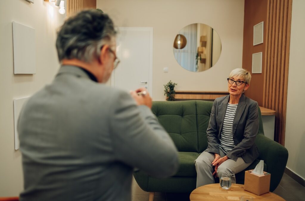 financial depression, A senior woman is having psychotherapy and proper medical care during her session.